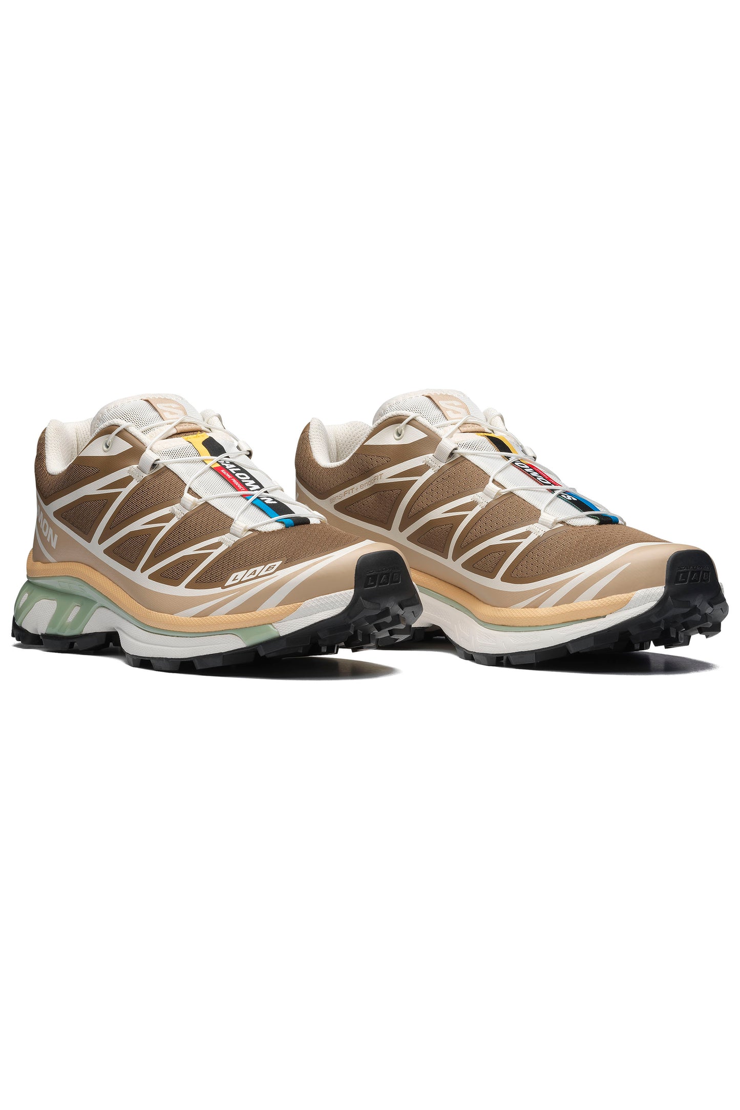 Pair of SALOMON XT-6 women's sneakers in coyote brown and safari colorway  on a white background