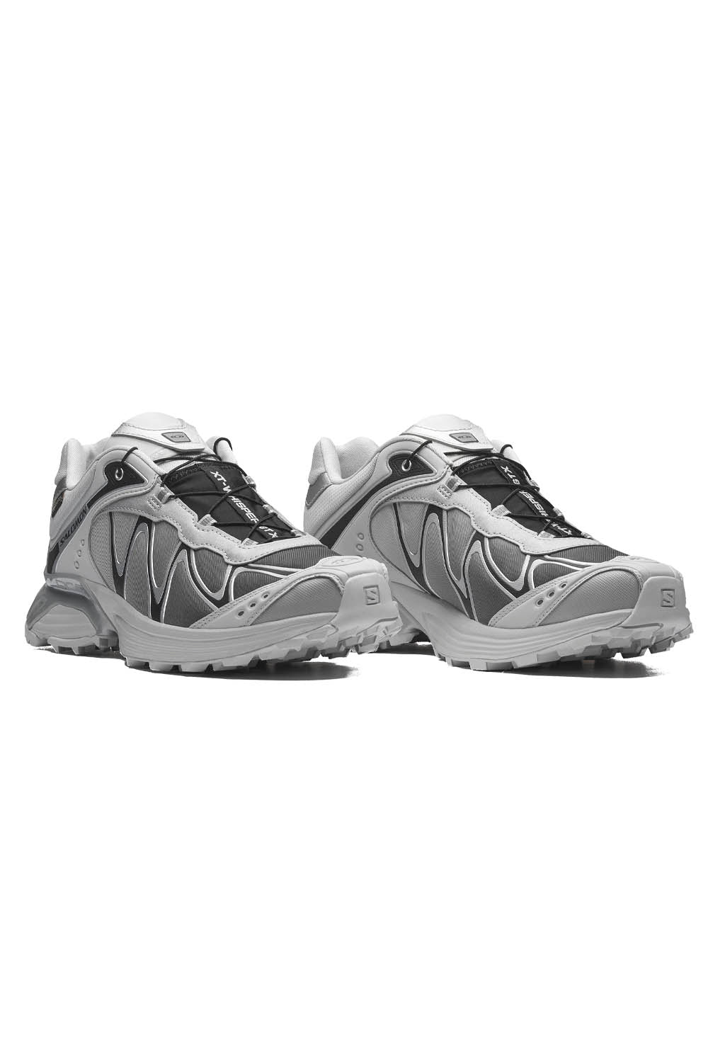 A pair of Salomon trail running shoes in gray and white with black laces, shown from a three-quarters angle on a white background.