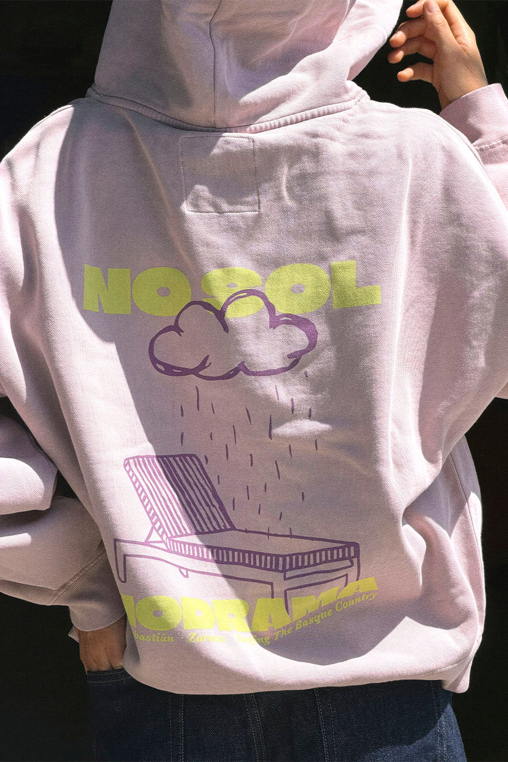 Light gray hoodie with colorful graphics and text on a dark background