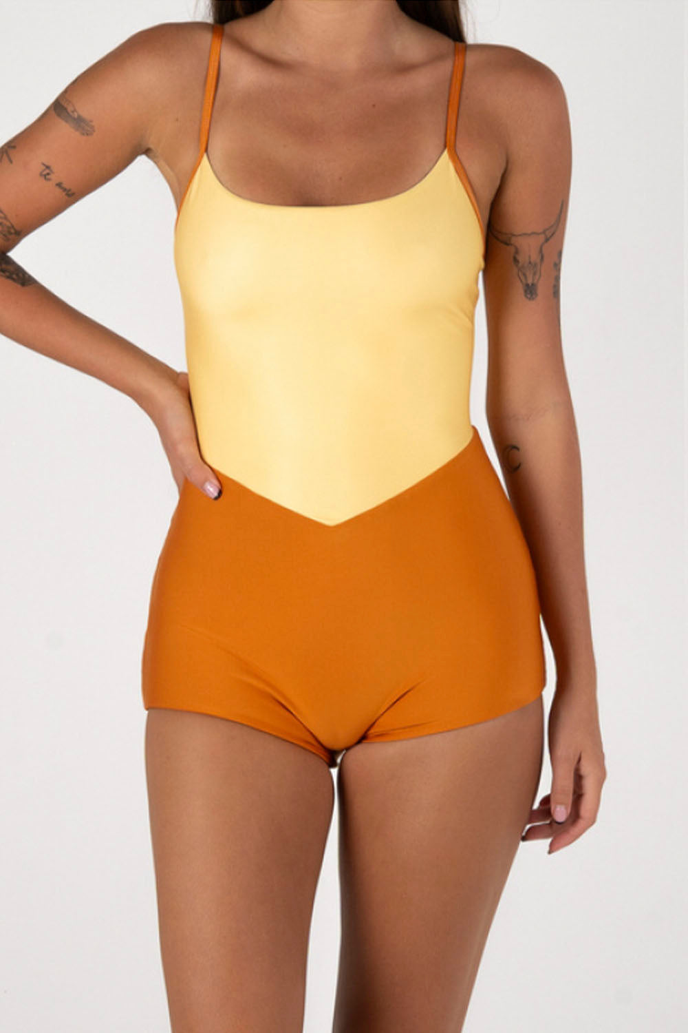 Person wearing a yellow and orange swimsuit on a white background