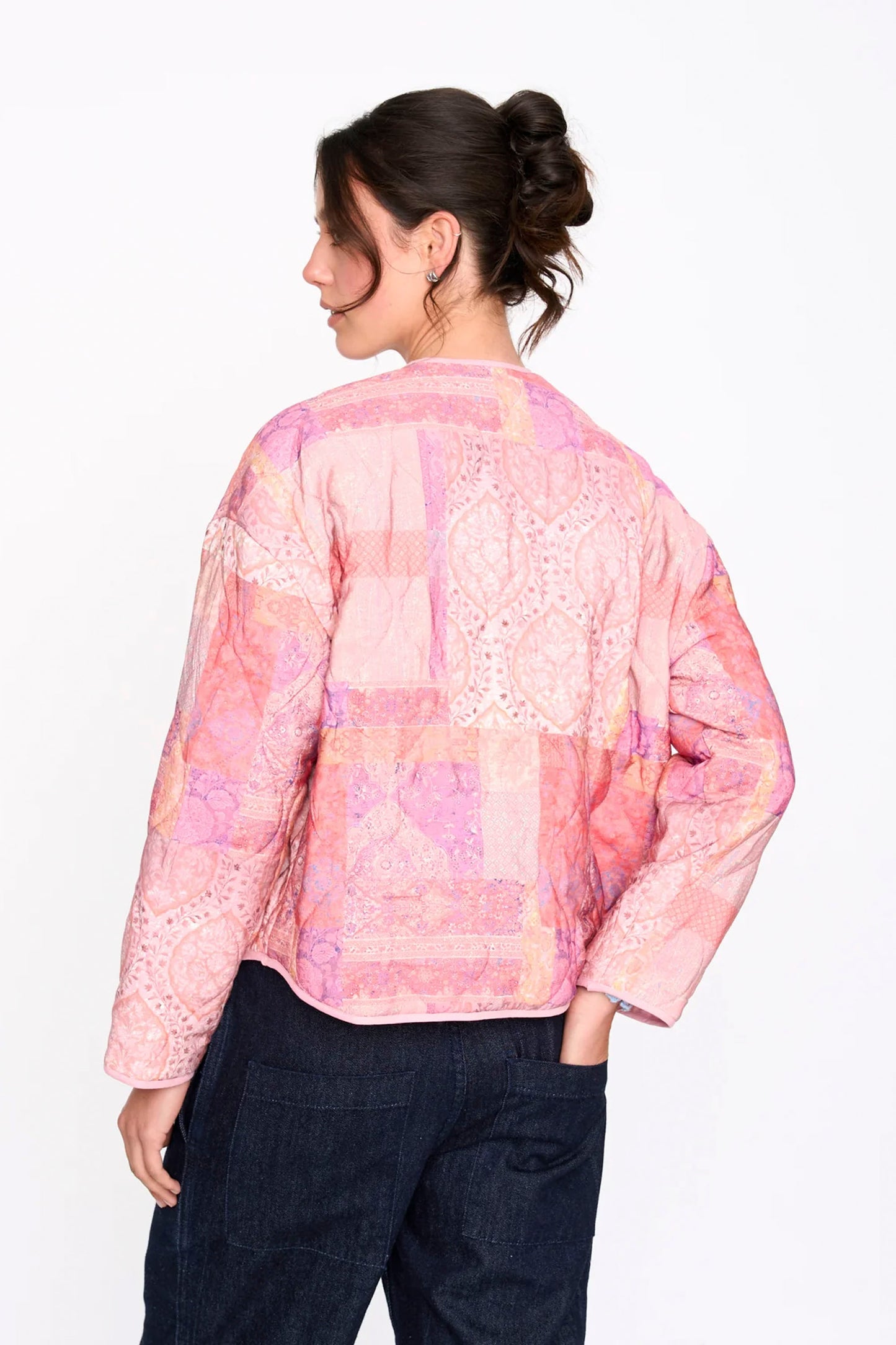Woman wearing a Pink 24colours patterned jacket on a white background