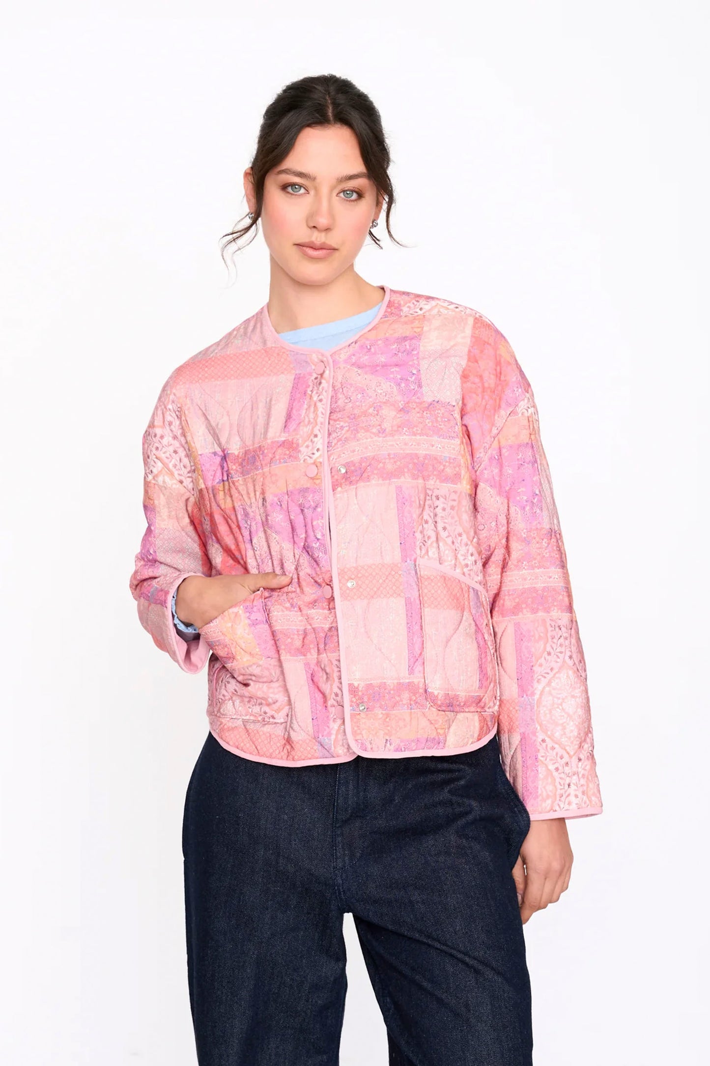 Woman wearing a Pink 24colours patterned jacket on a white background