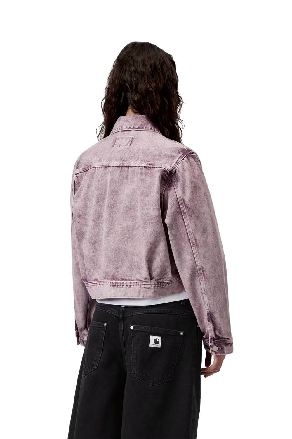 Person wearing a light purple denim jacket on a white background