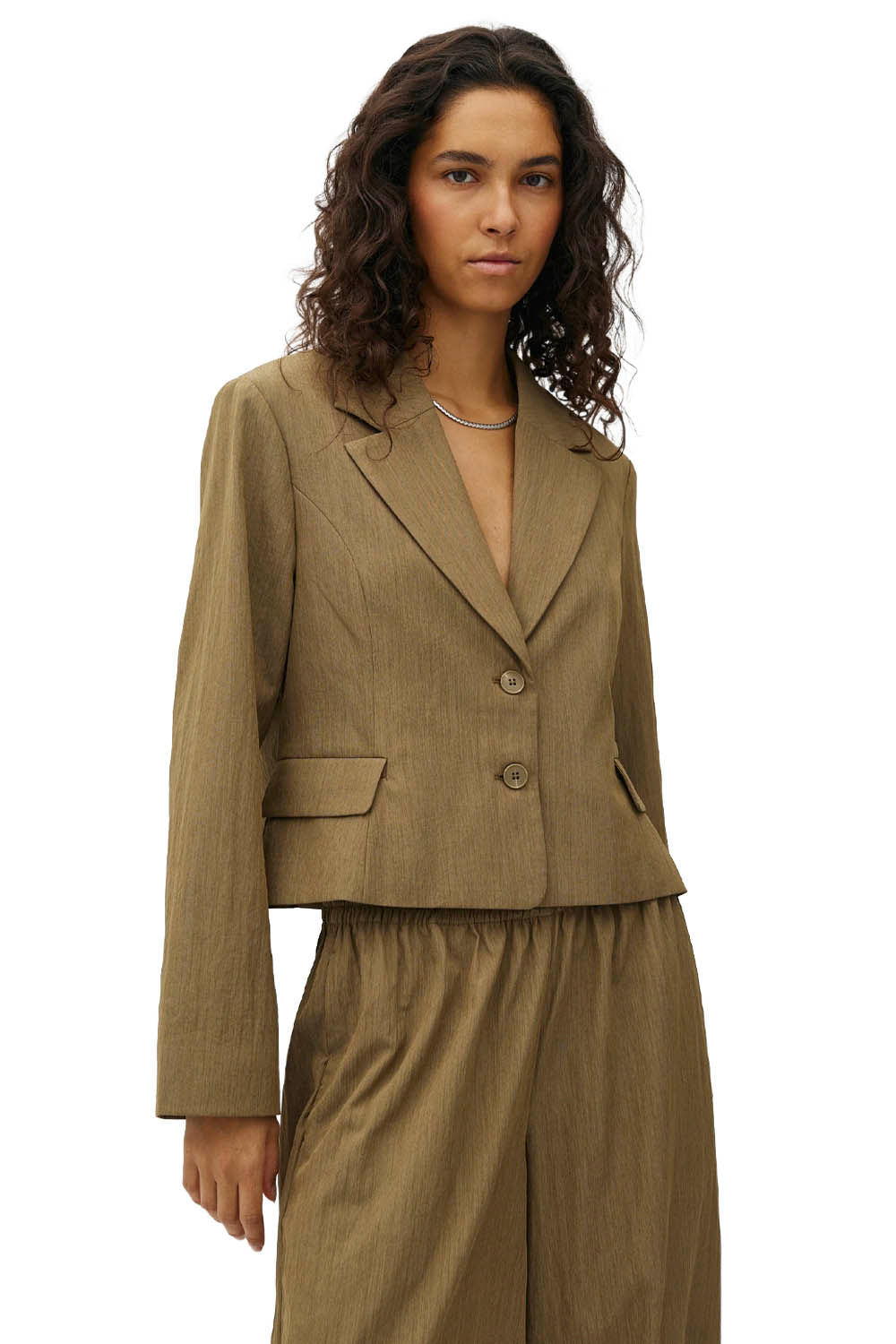 A model wearing a cropped, two-button blazer and matching wide-leg trousers in a textured khaki-brown fabric, set against a plain white background.