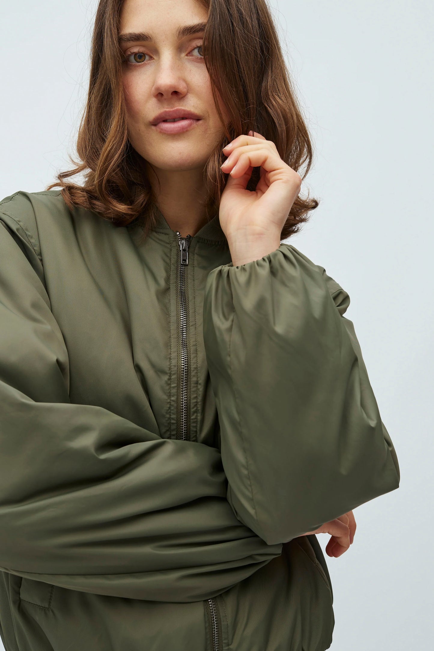Woman wearing a green mbyM Michi Jacket on a white background