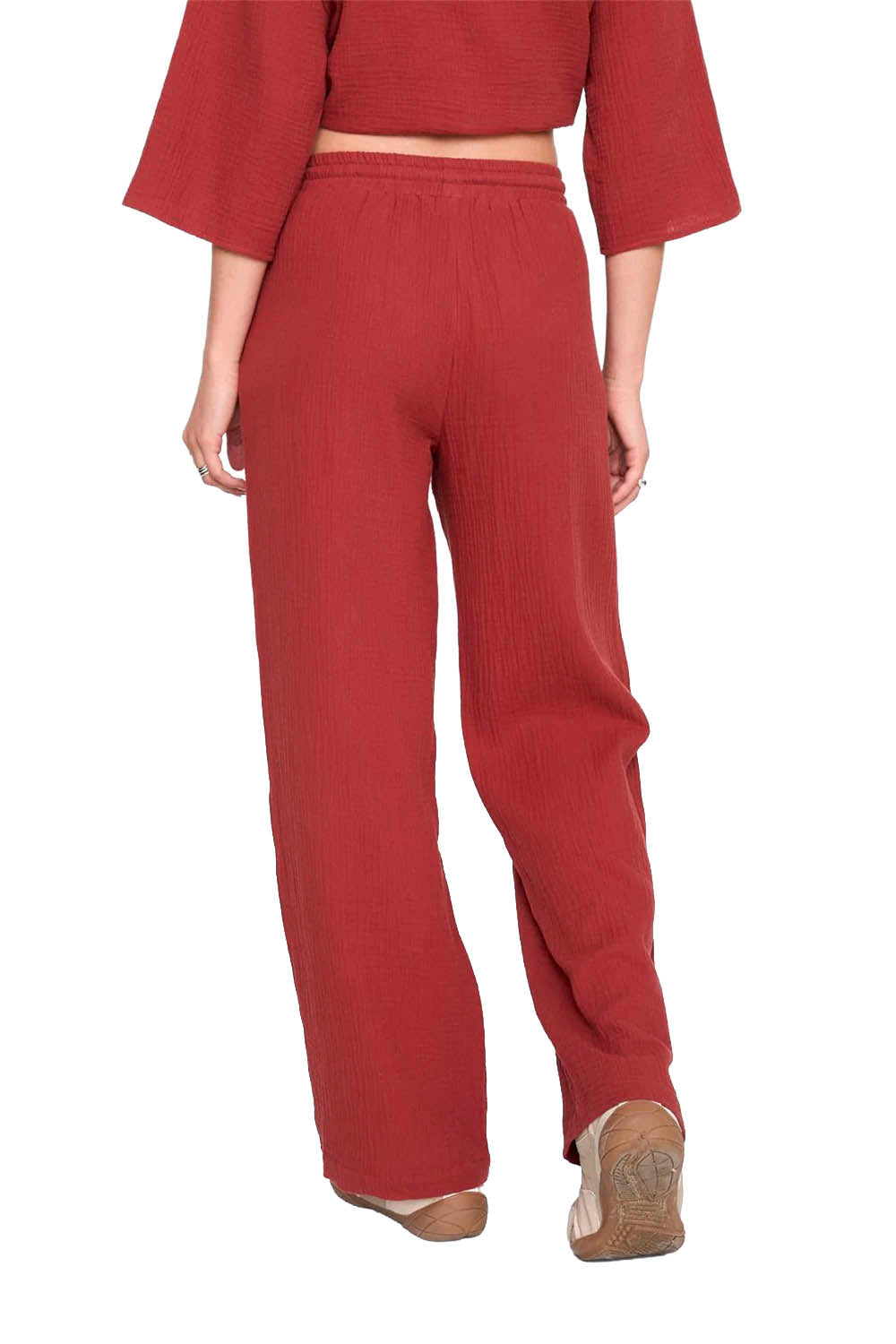 Red outfit with a cropped top and wide-leg pants on a white background