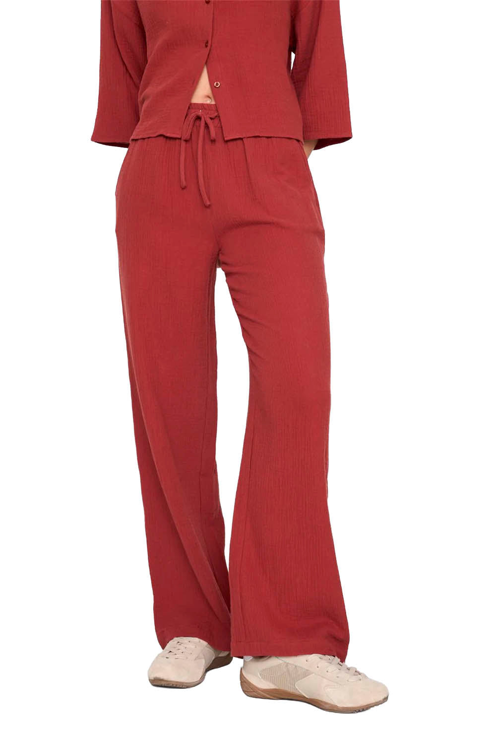 Red outfit with a top and pants on a white background