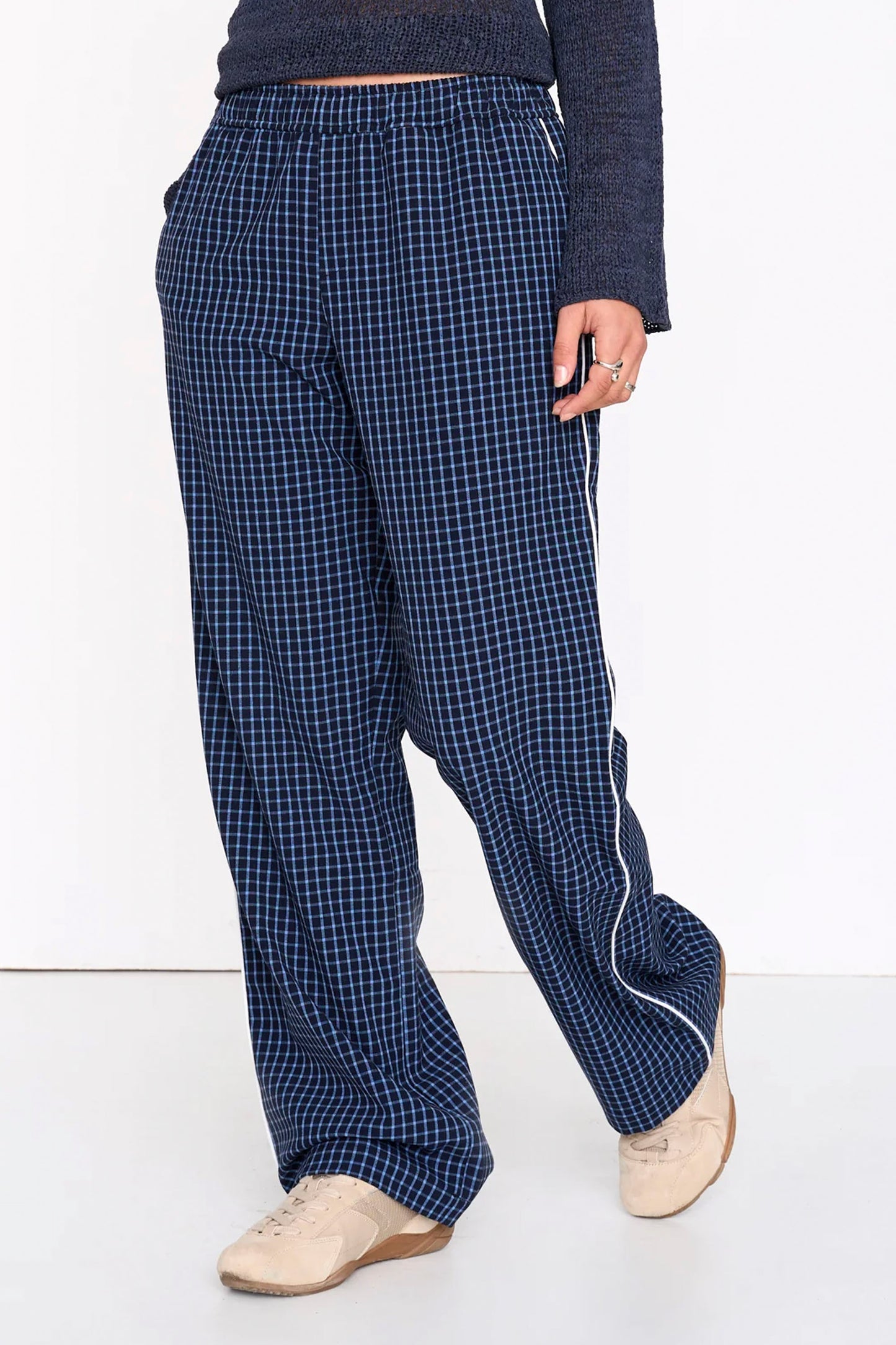 Woman wearing blue 24colours checked pants on a white background