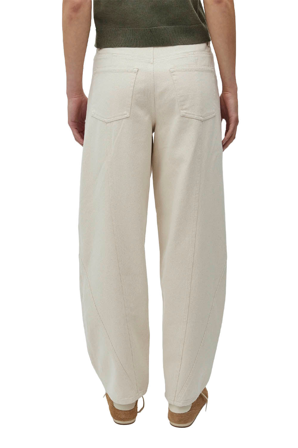 Beige pants worn by a person on a white background