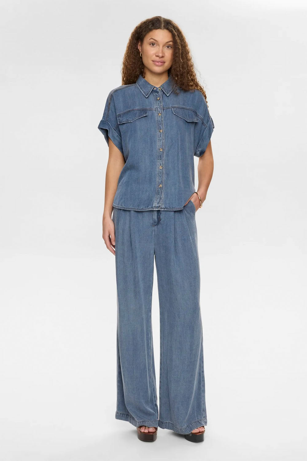 NÜMPH Nuelida Pants in Snow Washed Denim – women's relaxed fit washed denim trousers, available at Pukas Surf Shop