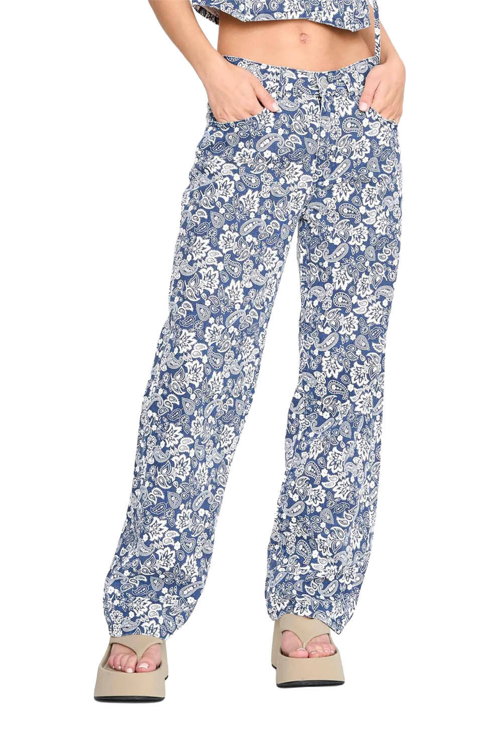 Floral-patterned pants worn by a person on a white background