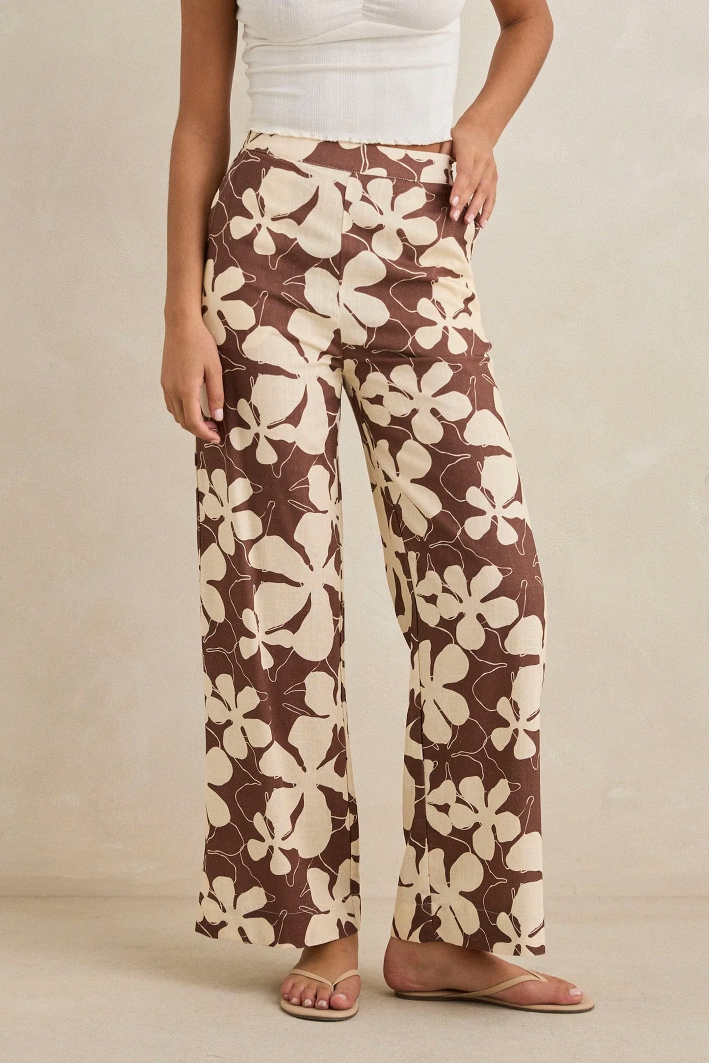 RHYTHM Melia Floral Wide Leg Pant in chocolate featuring delicate floral detailing and flowing silhouette