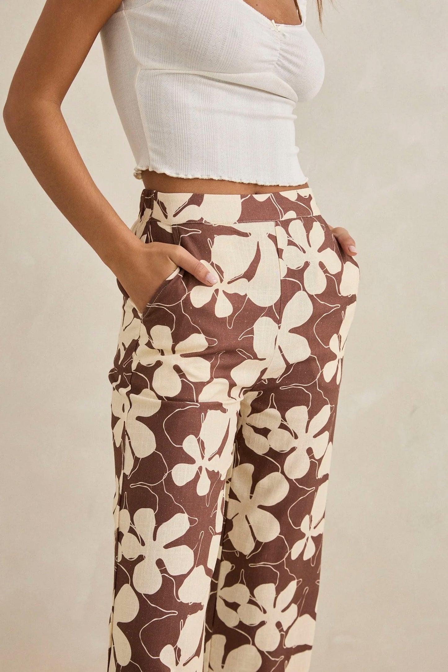 RHYTHM Melia Floral Wide Leg Pant in chocolate featuring delicate floral detailing and flowing silhouette