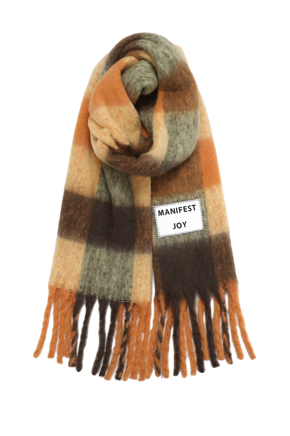 A plaid scarf in shades of orange, brown, beige, and gray with fringe ends and a white patch reading 'MANIFEST JOY' on a plain white background.
