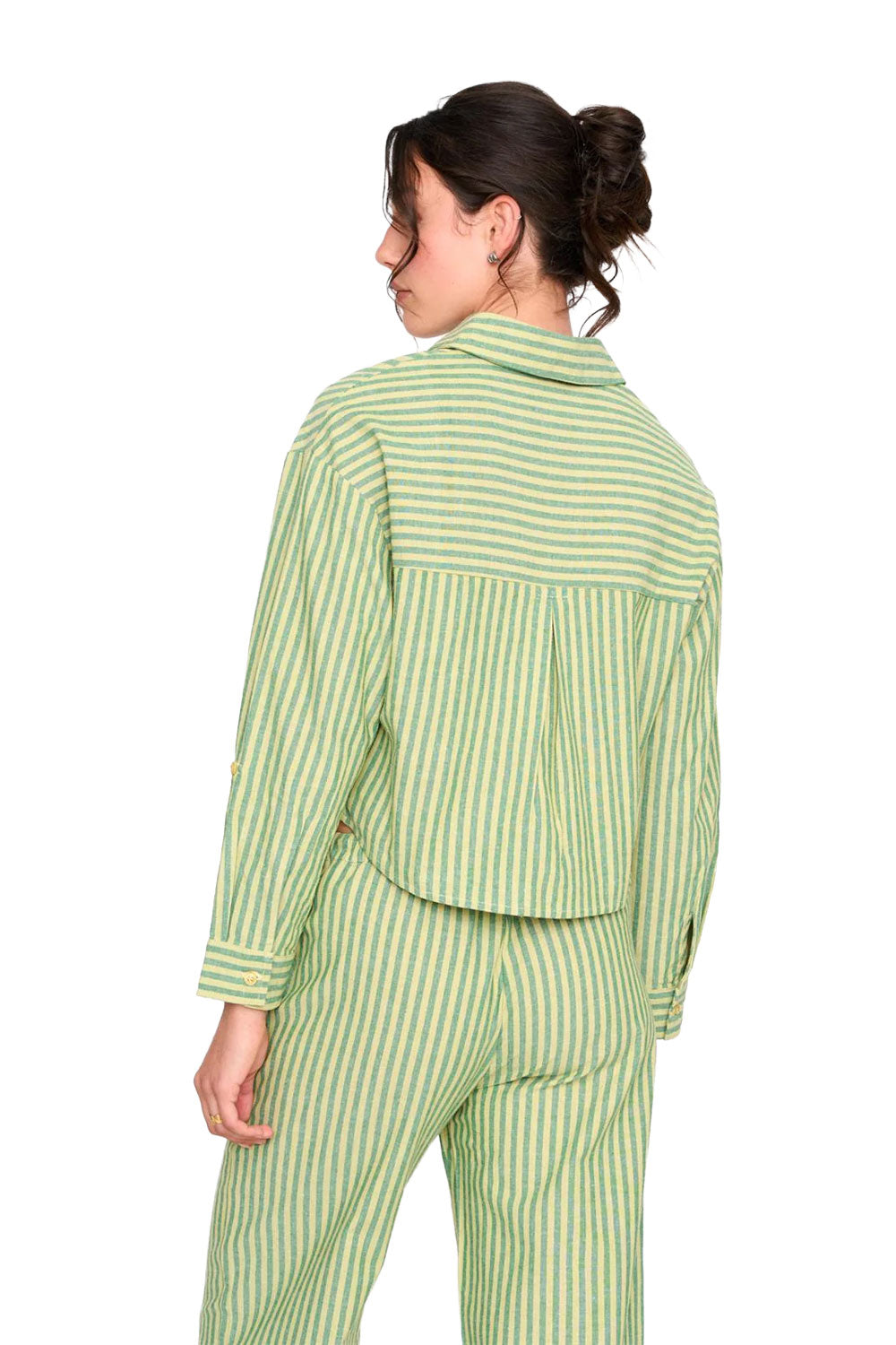 Woman wearing a green and white striped outfit on a white background