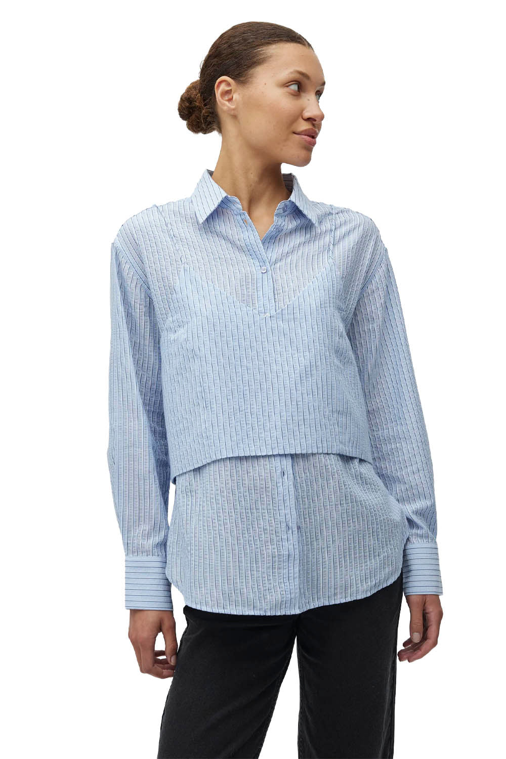 Woman wearing a light blue striped shirt on a white background