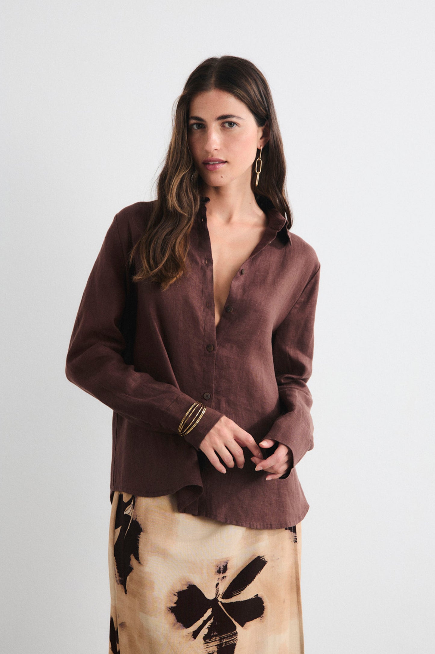 Woman wearing a brown blouse with a white background