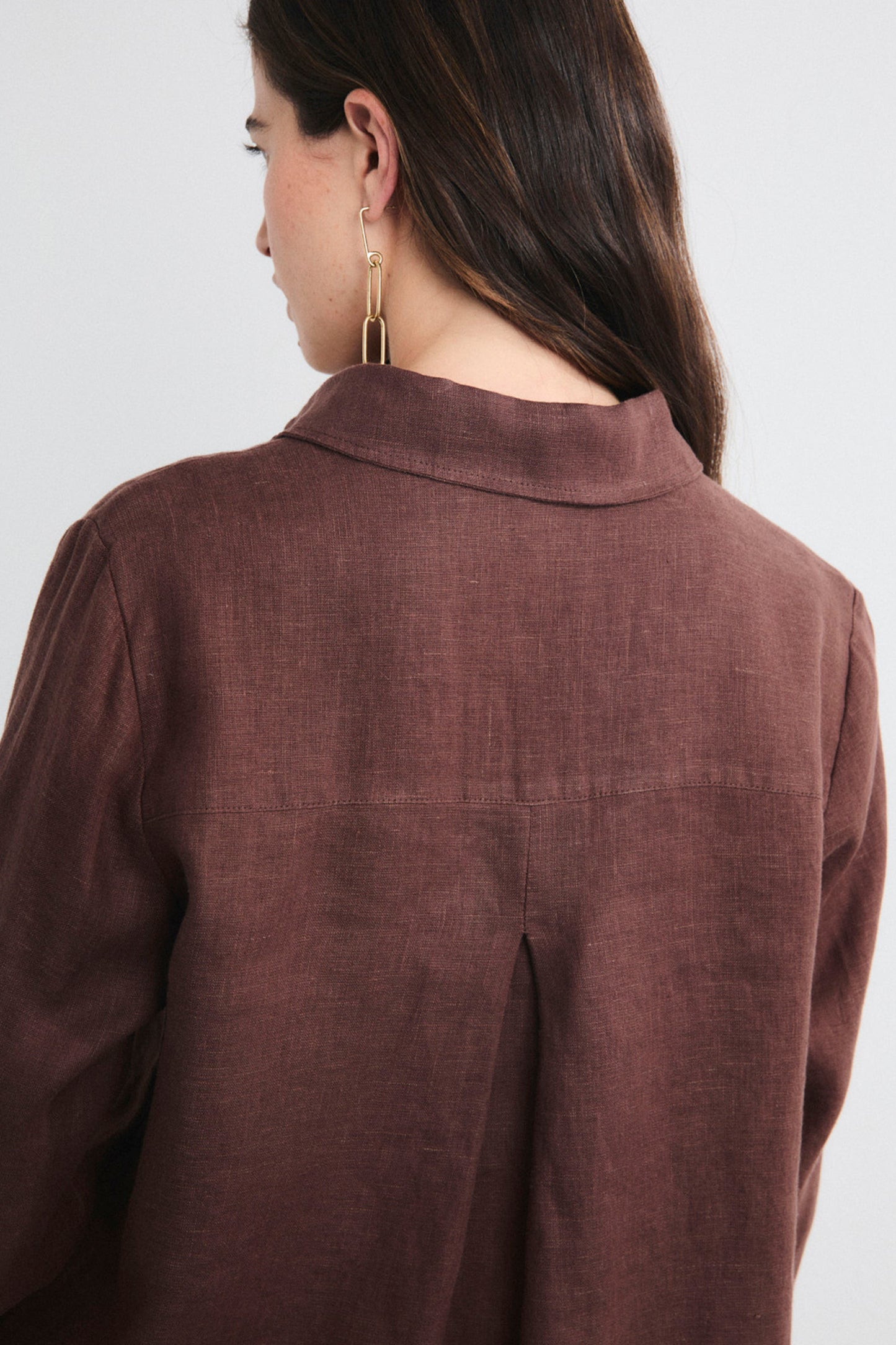 Brown shirt worn by a person on a white background