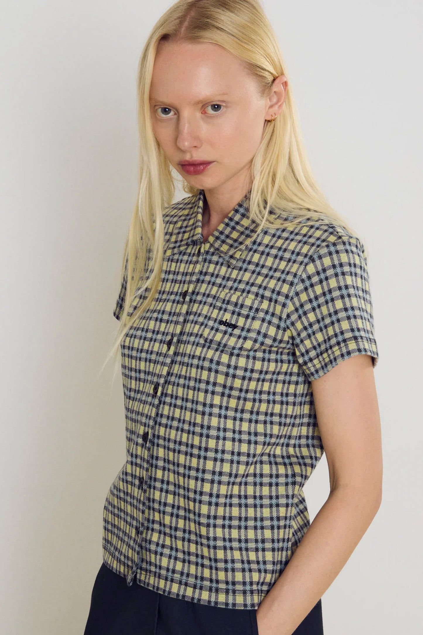 Woman wearing a checkered Obey Lila Micro shirt against a plain background