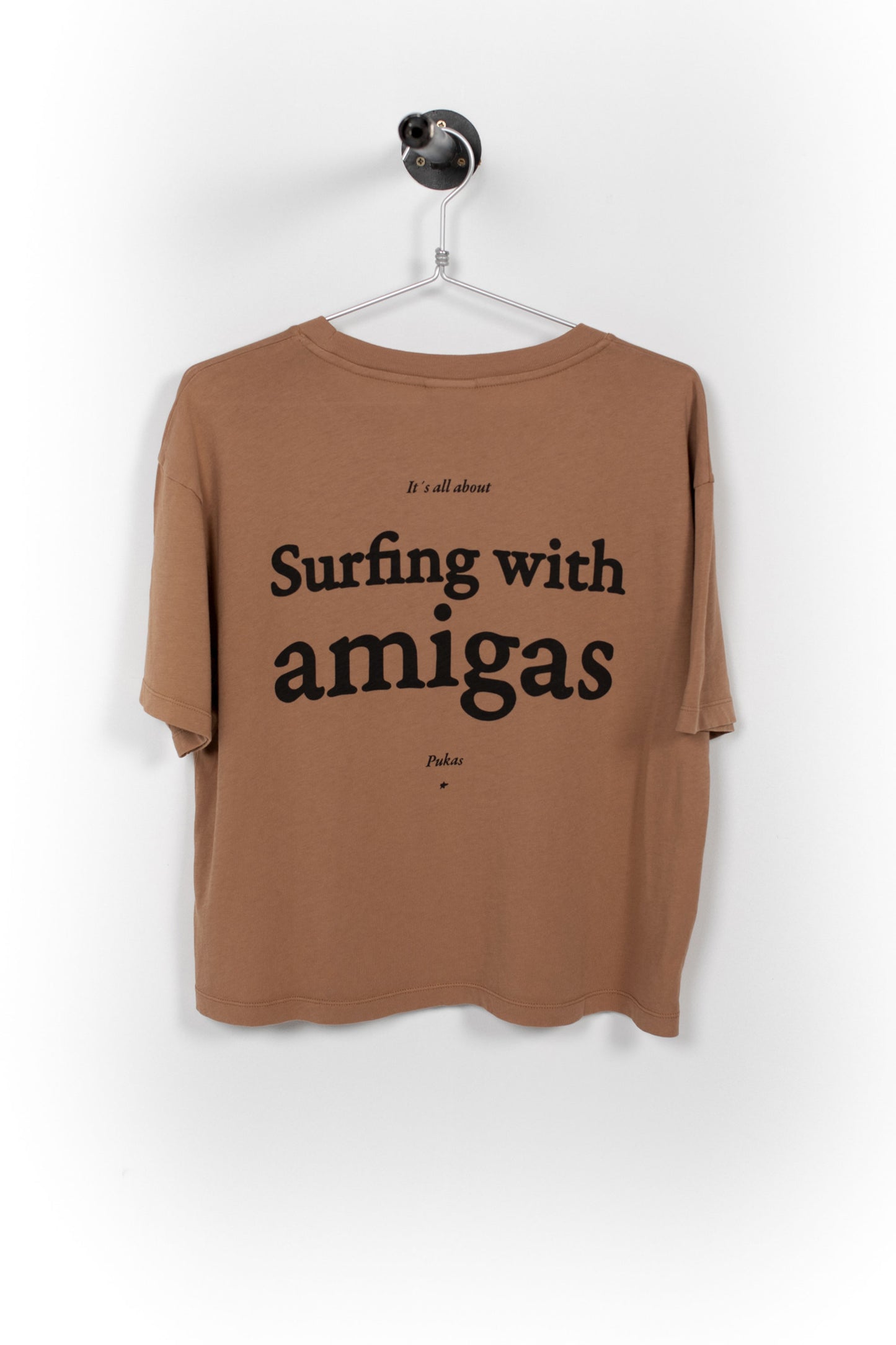Brown t-shirt with 'Surfing with amigas' text on a white background