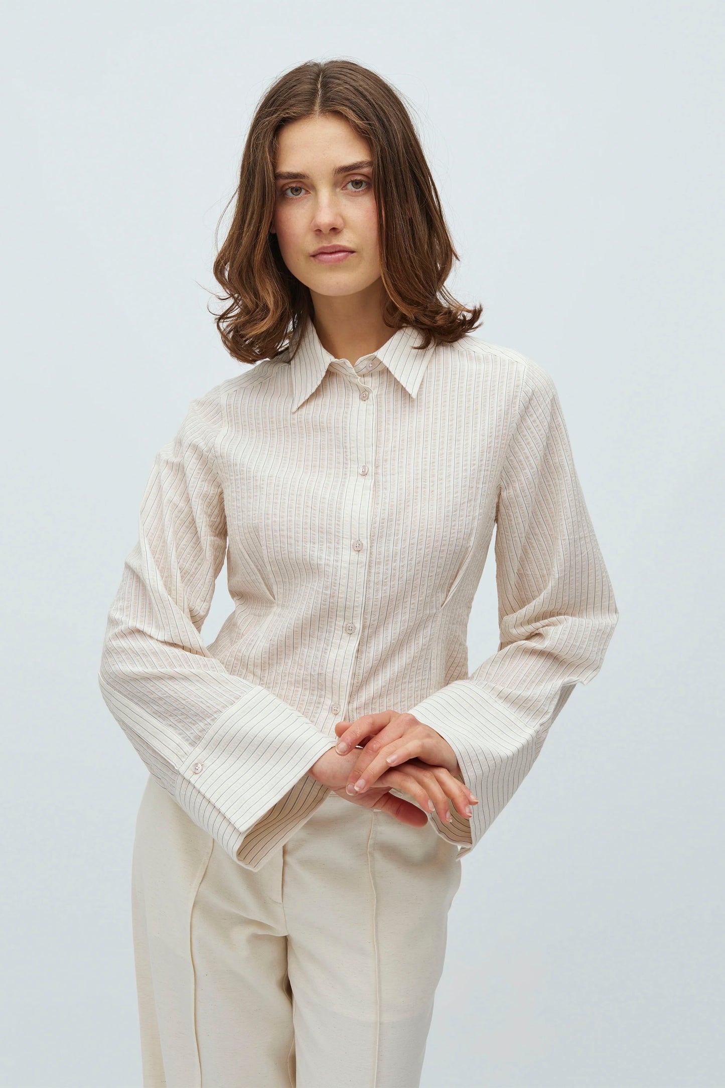 Woman wearing striped mbyM Kalanna shirt on a white background