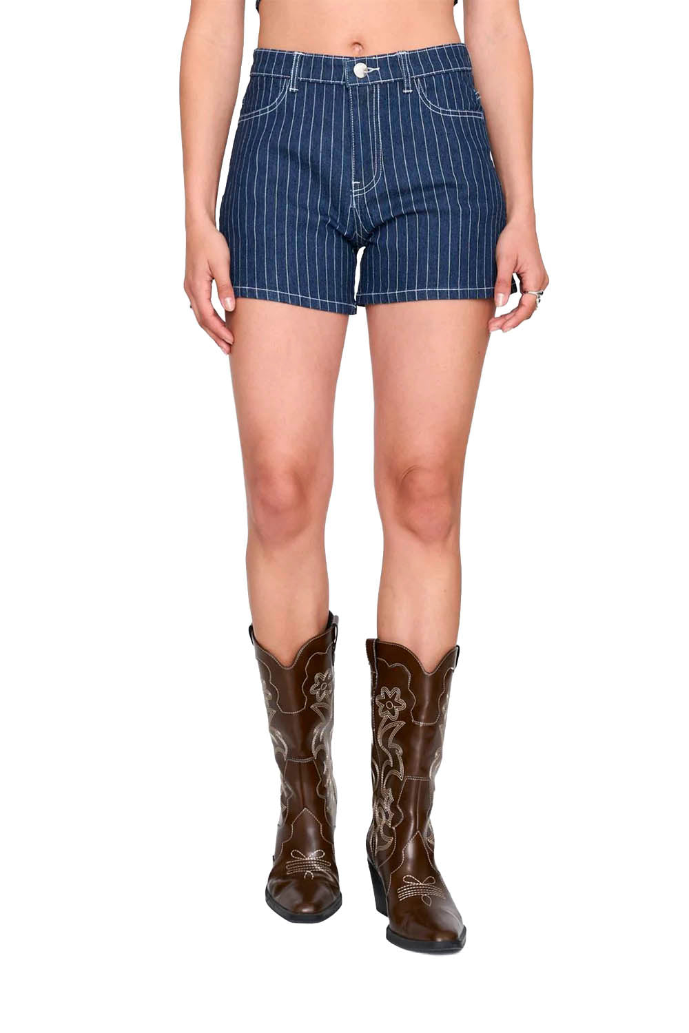 Person wearing blue pinstripe shorts and brown cowboy boots on a white background
