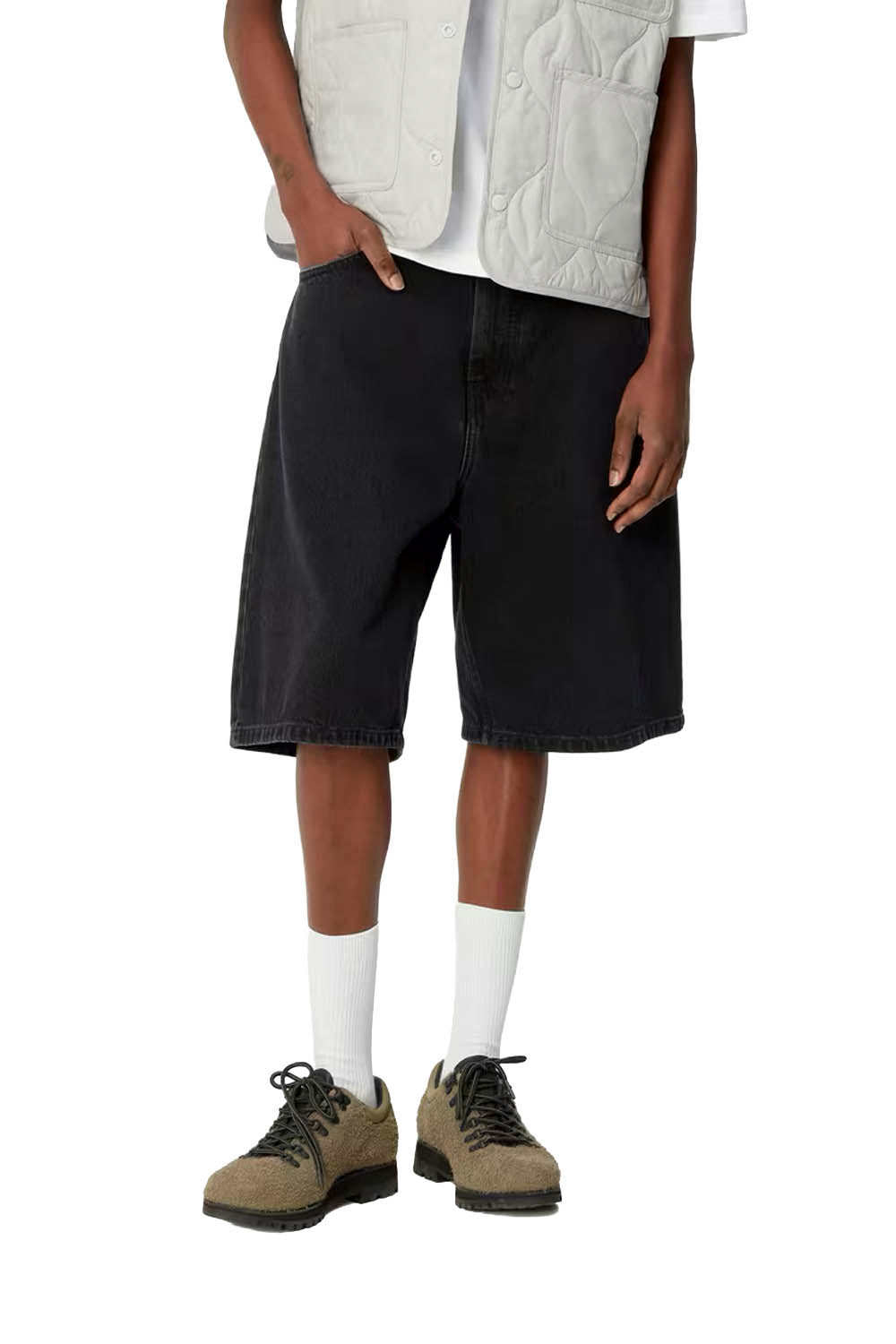 Person wearing black shorts, white shirt, and hiking boots on a white background