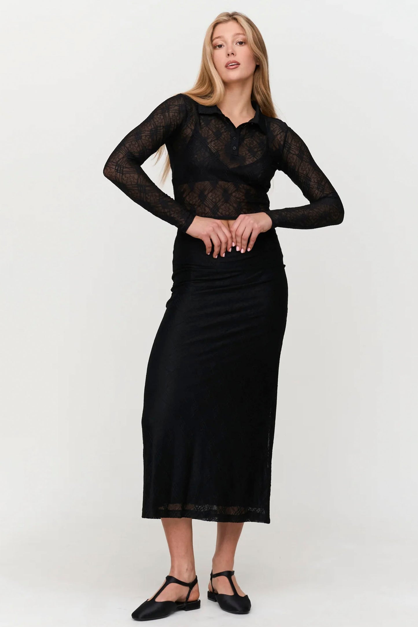 Textured black midi skirt with structured fit and minimal elegant design