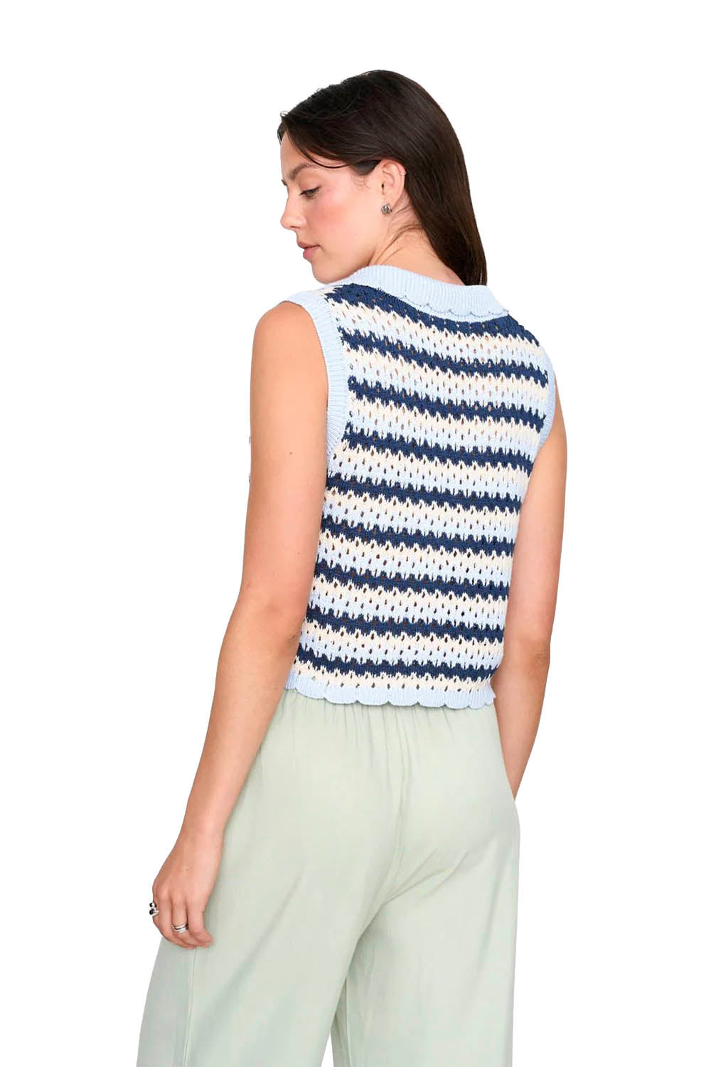 Woman wearing a sleeveless striped sweater on a white background