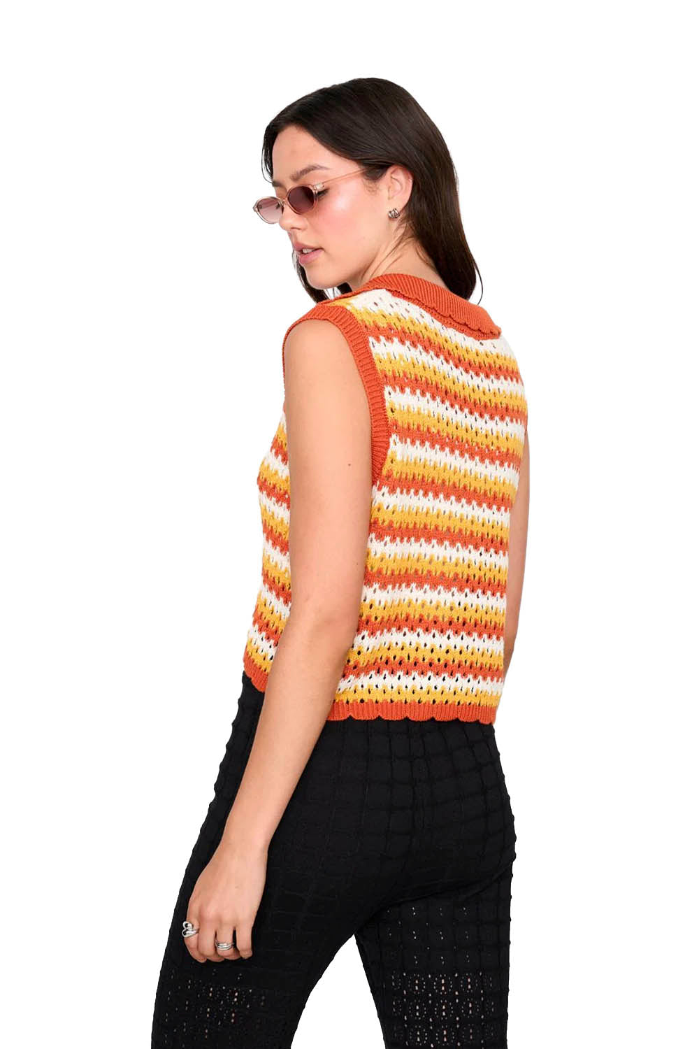 Woman wearing a colorful striped sleeveless top on a white background
