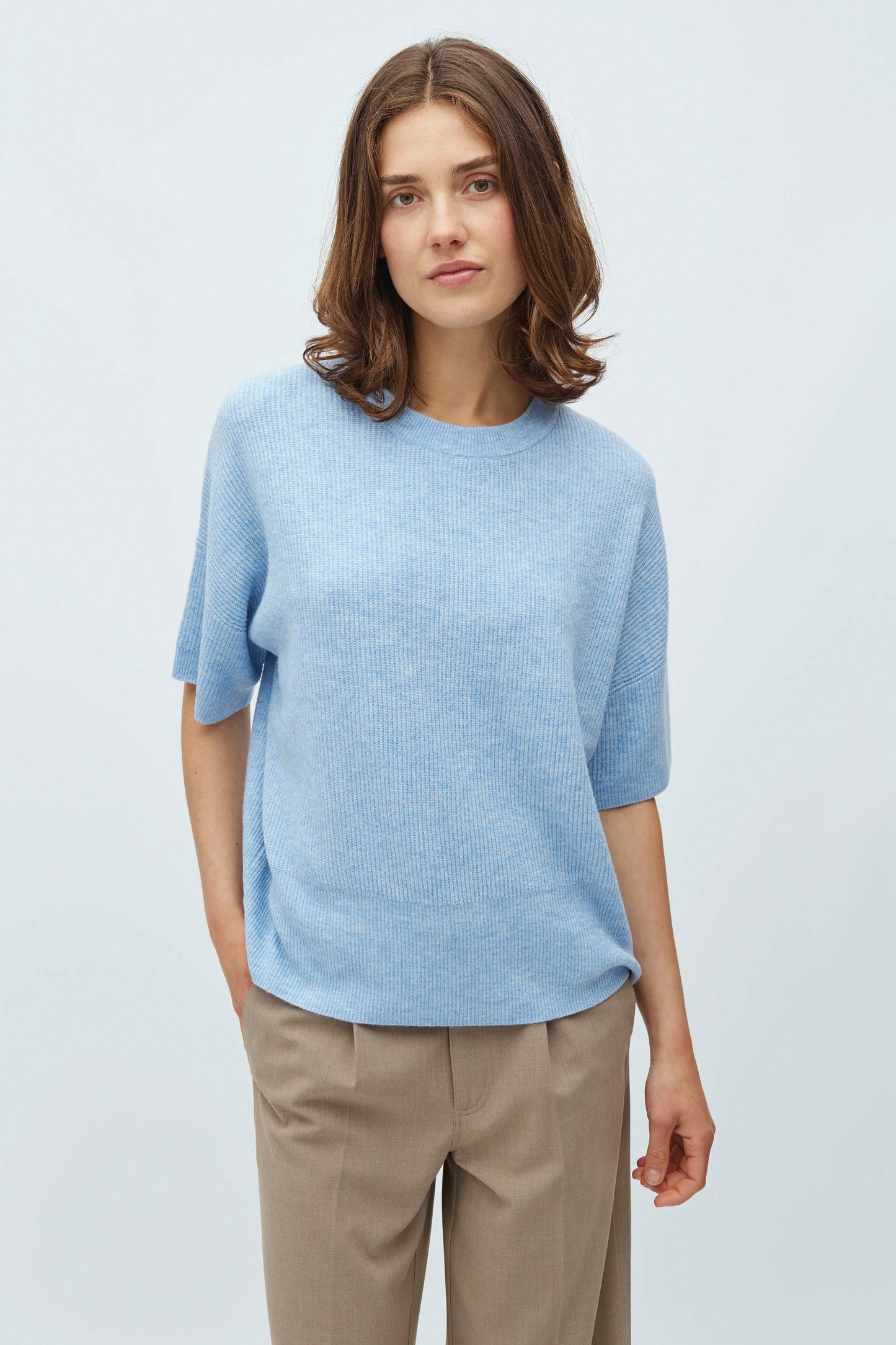 Woman wearing a Light blue mbyM Gillian Knit Top on a white background