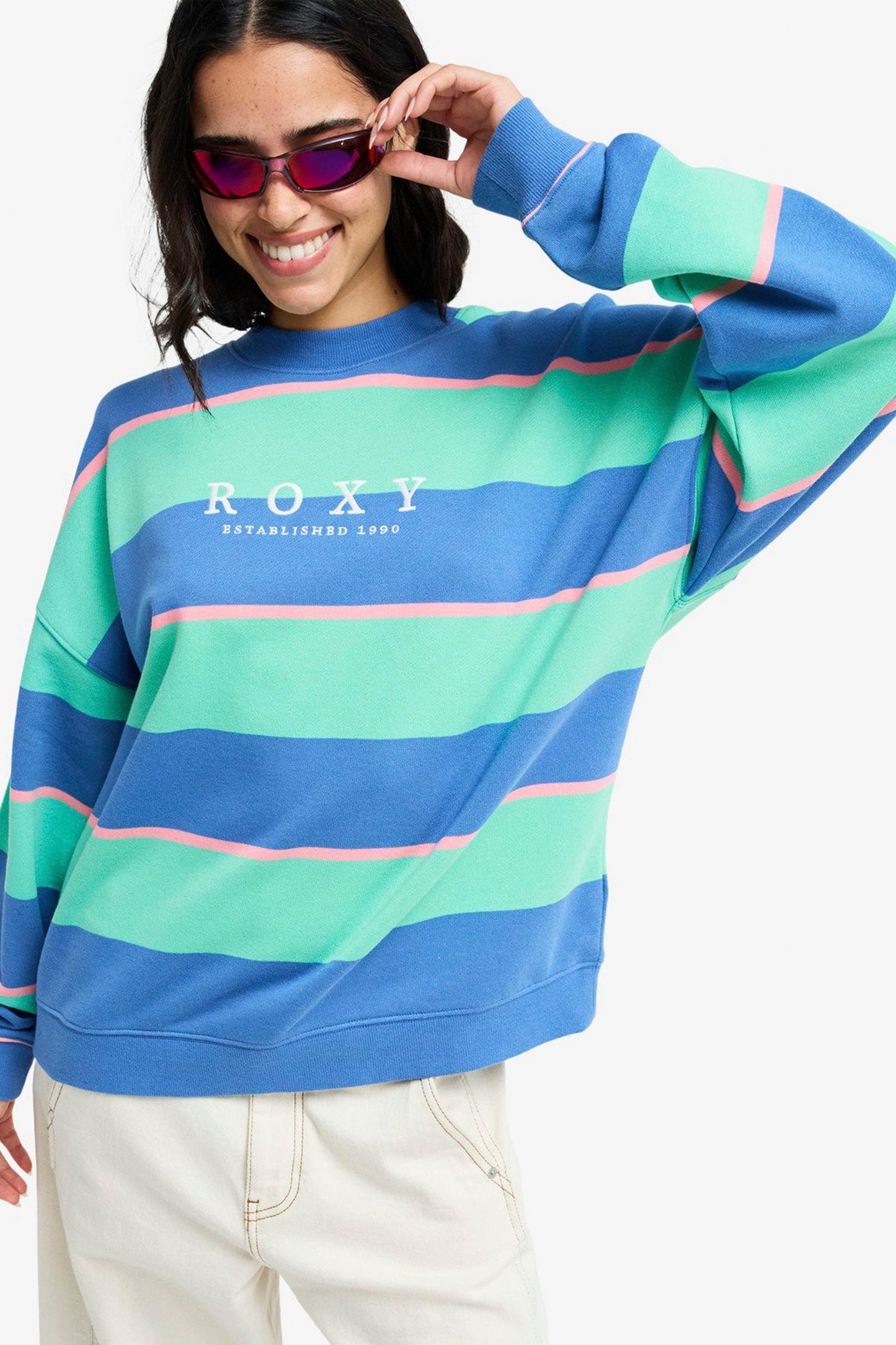 Person wearing a ROXY Strictly Stripes oversized sweatshirt on a white background