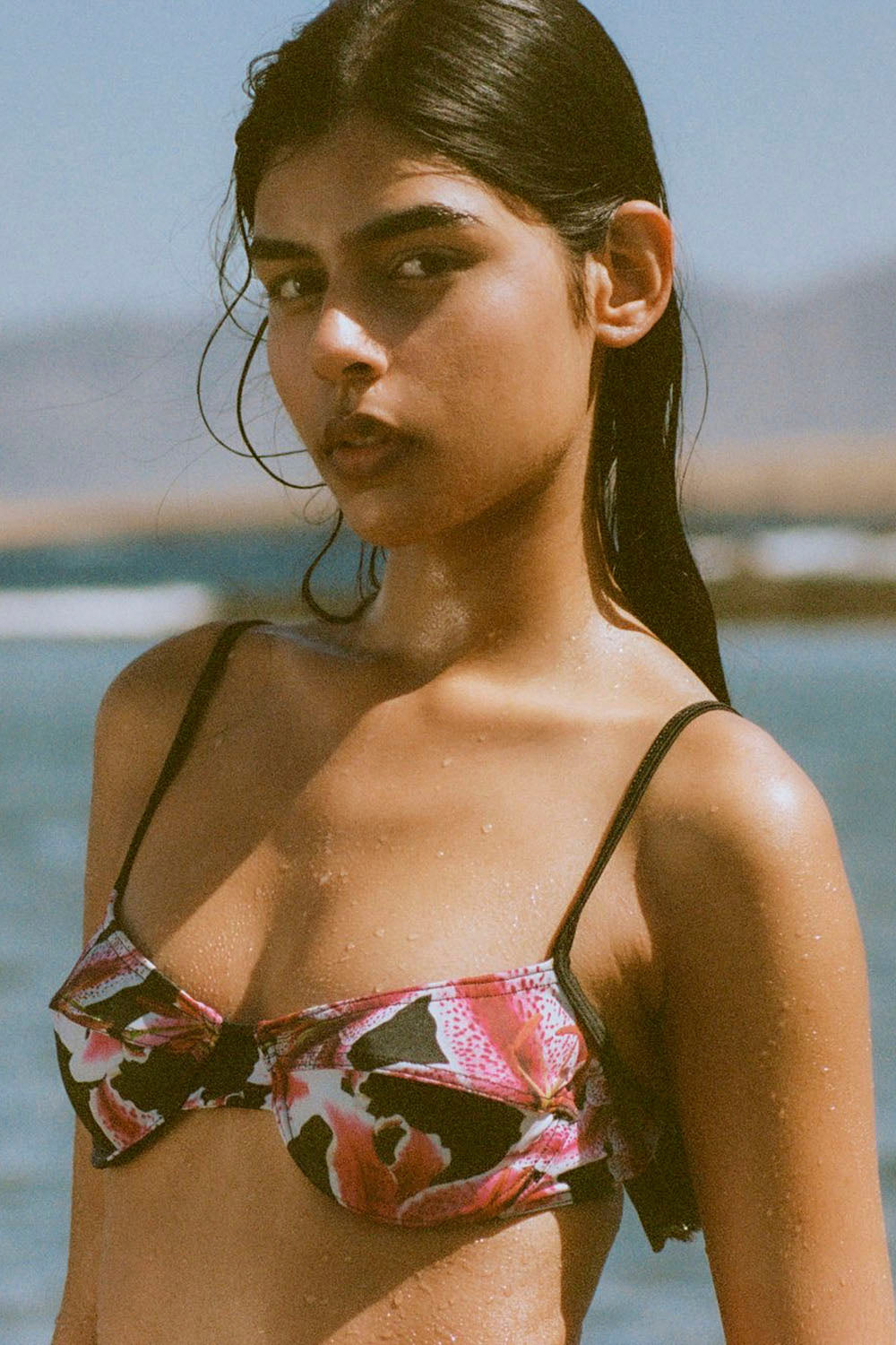 Woman wearing a floral bikini top with a blurred background