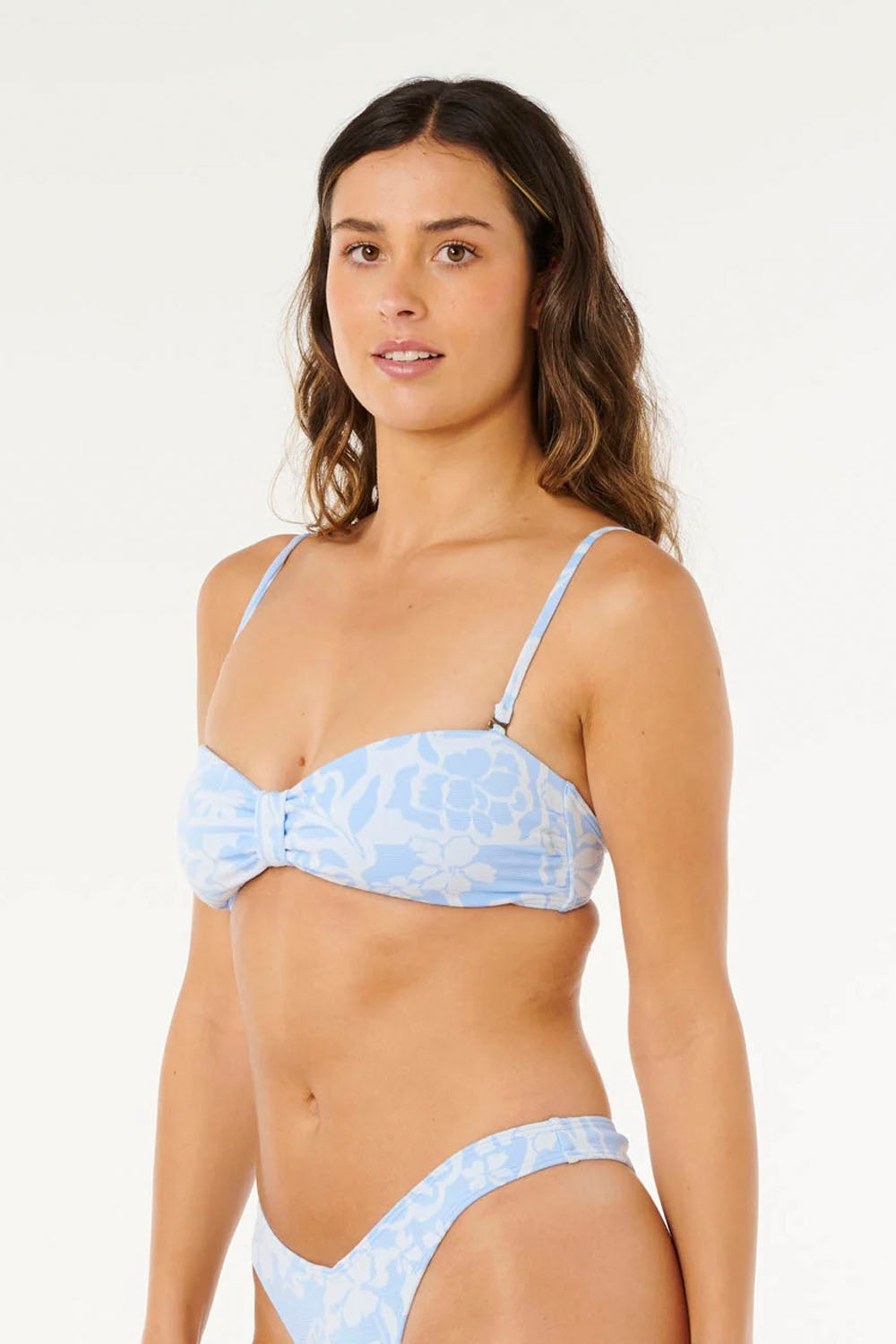 Woman wearing a light blue bikini with a white background