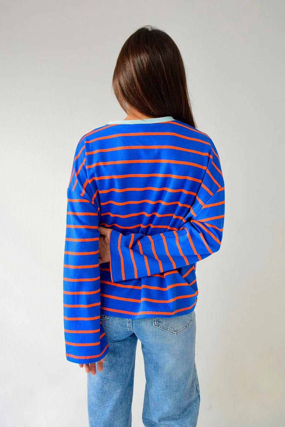 Mind Traveler BCN Miriam women's long sleeve tee in blue with orange stripes and a contrasting pale blue crew neck
