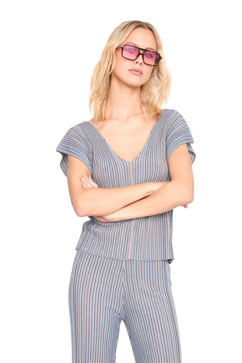 Woman wearing a striped top and sunglasses on a white background