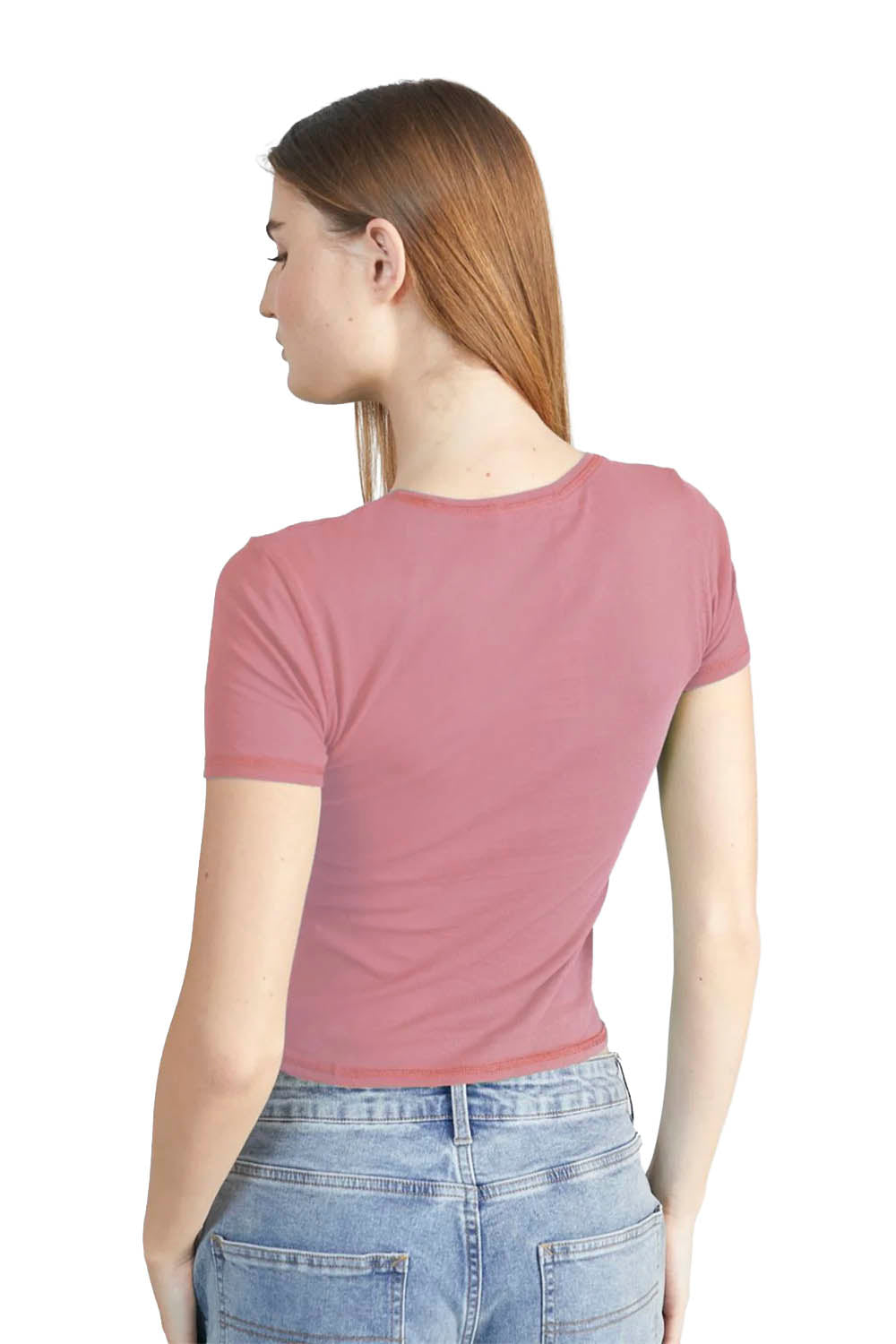 Woman wearing a mauve t-shirt and blue jeans on a white background