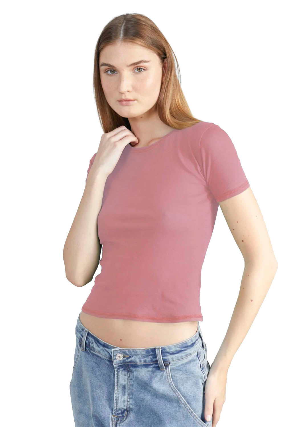 Woman wearing a mauve t-shirt and blue jeans on a white background