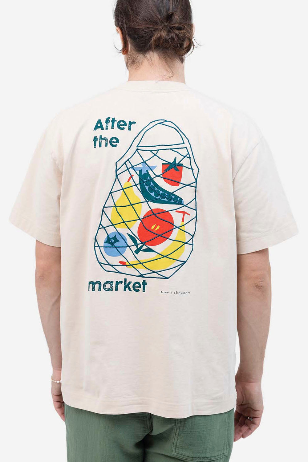 Person wearing a t-shirt with a colorful graphic design on the back