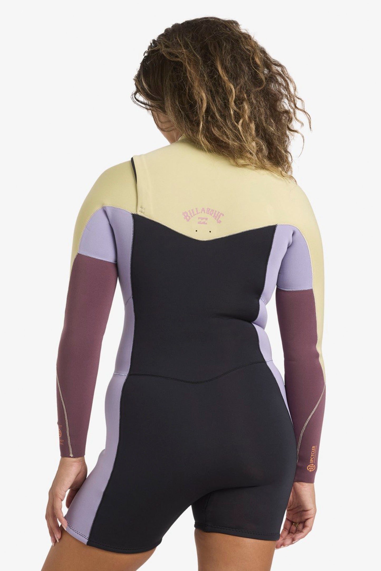 Woman wearing Billabong Synergy springsuit on a white background